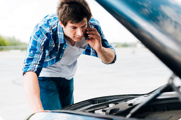 Driver staying safe roadside with warning triangle